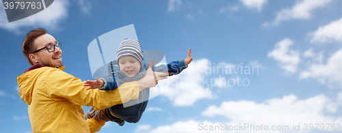 Image of father with son playing and having fun outdoors