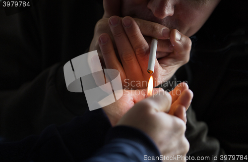 Image of close up of young people smoking cigarette