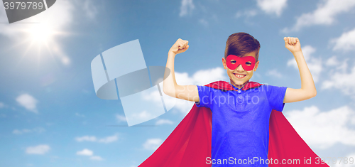 Image of boy in red superhero cape and mask showing fists