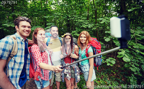 Image of friends with backpack taking selfie by smartphone