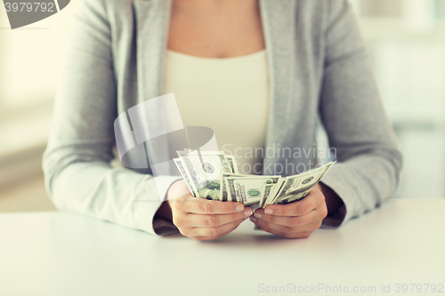 Image of close up of woman hands counting us dollar money