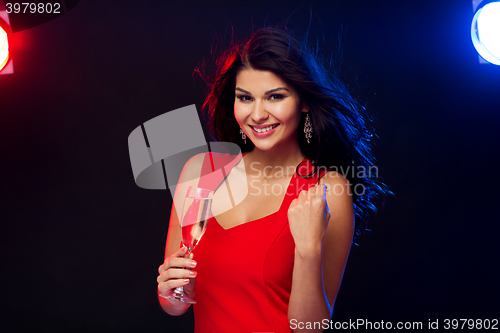 Image of beautiful woman with champagne glass at nightclub