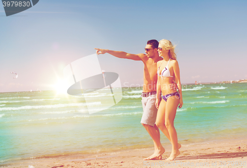 Image of couple walking on the beach