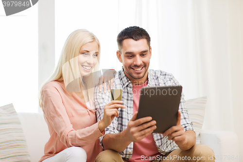 Image of happy couple with tablet pc and credit card