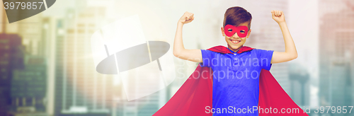 Image of boy in red superhero cape and mask showing fists
