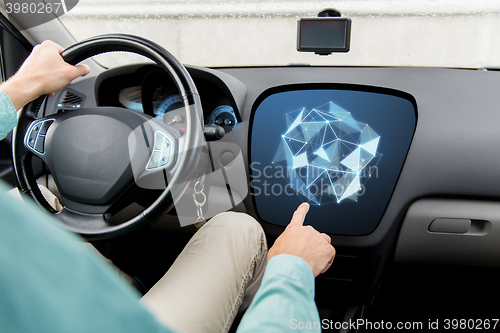 Image of man driving car and pointing to on-board computer