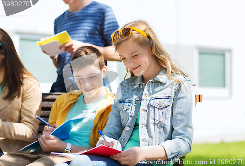 Image of group of students with notebooks at school yard