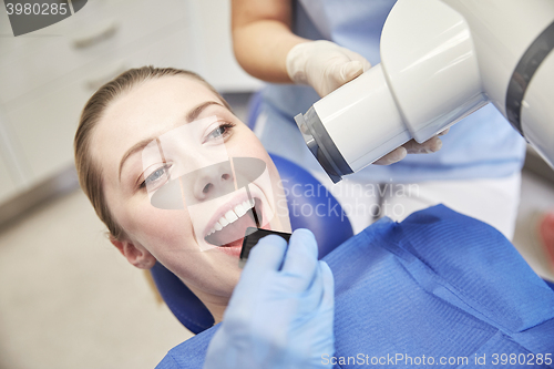 Image of female patient face with x-ray machine and shield