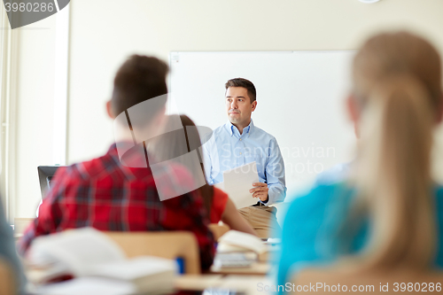 Image of group of students and teacher with tests