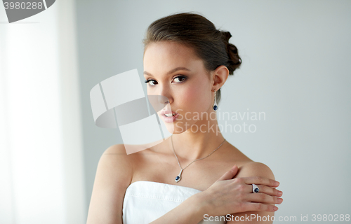 Image of beautiful woman with earring, ring and pendant