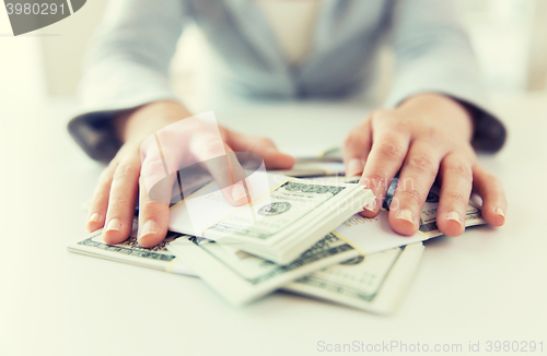 Image of close up of woman hands counting us dollar money