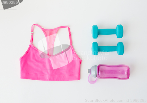 Image of close up of sports top, dumbbells and bottle