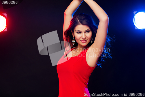 Image of beautiful sexy woman in red dancing at nightclub