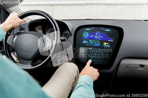 Image of close up of man driving car with navigation system