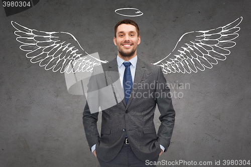 Image of smiling businessman with angel wings and nimbus