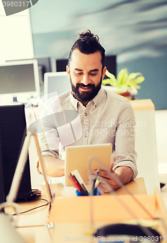 Image of happy creative male office worker with tablet pc
