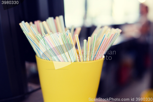 Image of close up of cocktail straws in glass at restaurant