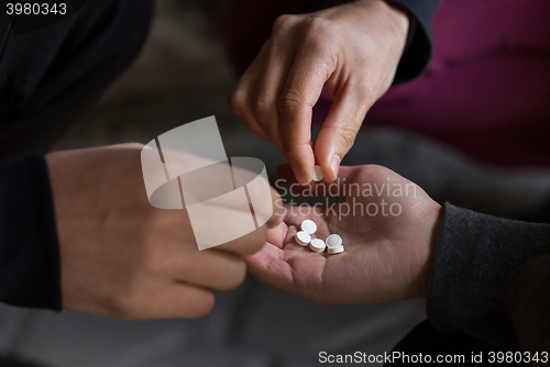 Image of close up of addicts using drug pills