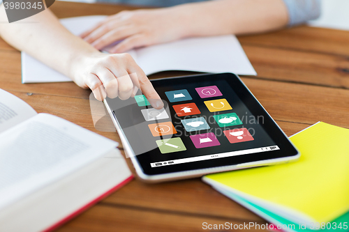 Image of close up of student with tablet pc and notebook