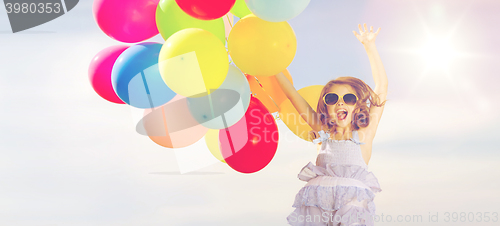 Image of happy jumping girl with colorful balloons