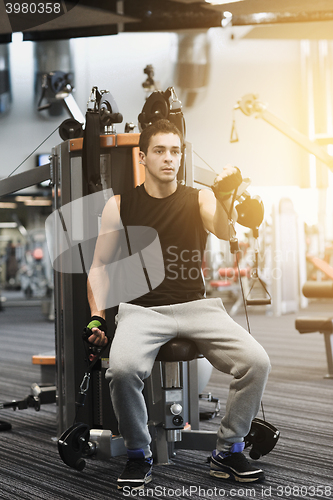 Image of man exercising on gym machine