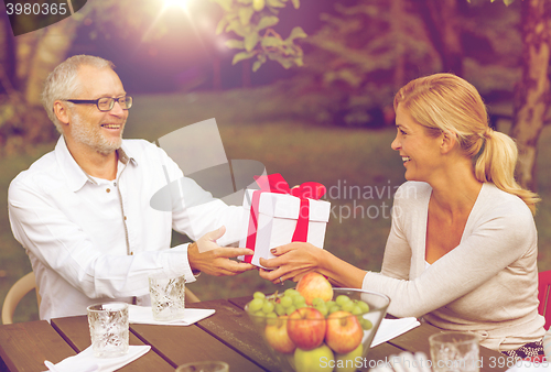 Image of happy family having holiday dinner outdoors