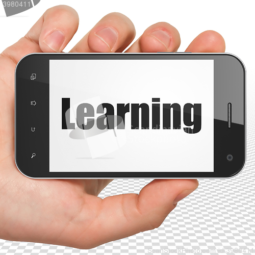 Image of Learning concept: Hand Holding Smartphone with Learning on display