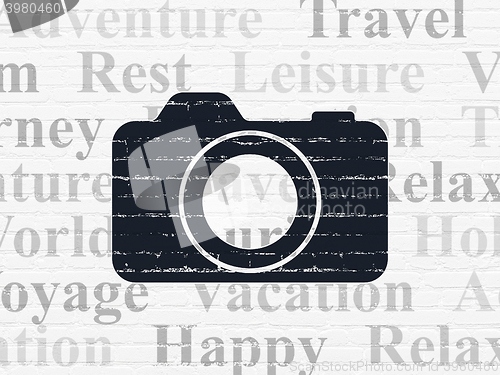 Image of Vacation concept: Photo Camera on wall background