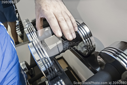 Image of grabbing a dumbbell