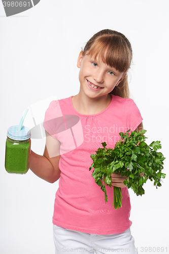 Image of Girl holding jar tumbler mug with green smoothie drink