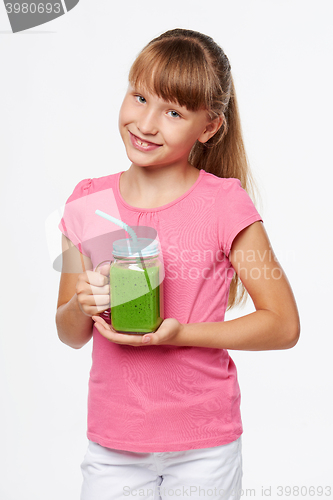 Image of Girl holding jar tumbler mug with green smoothie drink