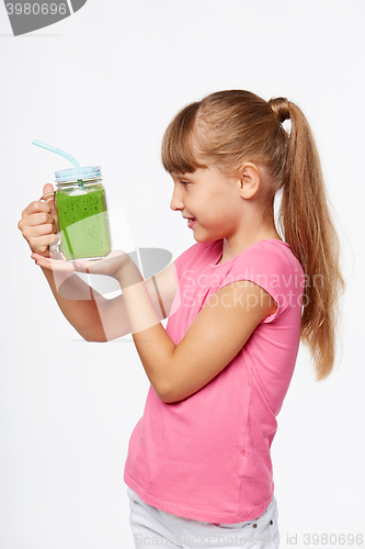 Image of Girl holding jar tumbler mug with green smoothie drink