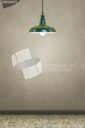 Image of green lamp in front of a brown wall