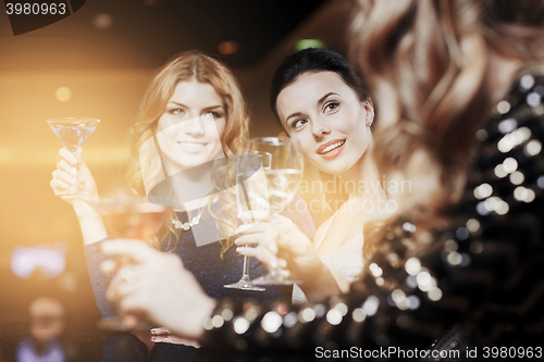 Image of happy women with drinks at night club