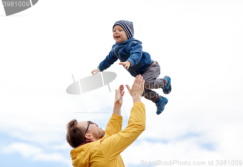 Image of father with son playing and having fun outdoors