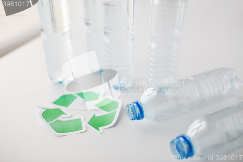 Image of close up of plastic bottles and recycling symbol