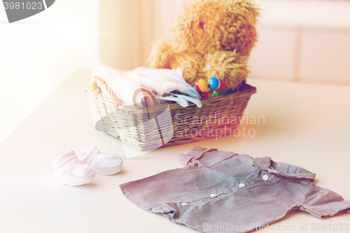 Image of close up of baby clothes and toys for newborn