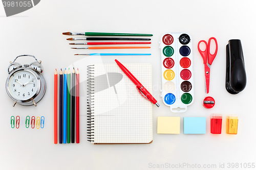 Image of School set with notebooks, pencils, brush, scissors and apple on white background