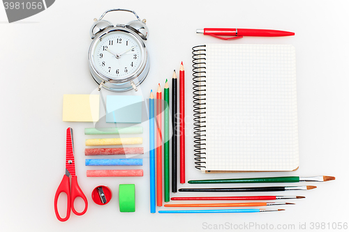 Image of School set with notebooks, pencils, brush, scissors and apple on white background