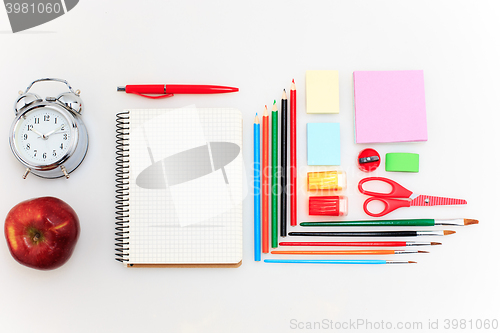 Image of School set with notebooks, pencils, brush, scissors and apple on white background