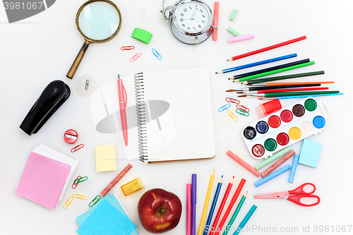 Image of School set with notebooks, pencils, brush, scissors and apple on white background