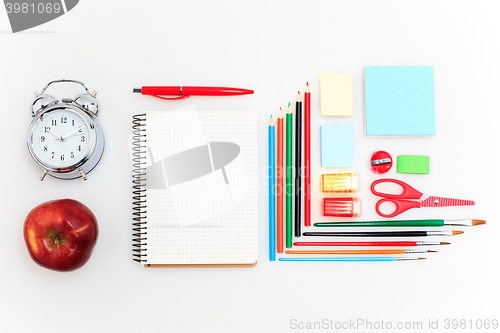 Image of School set with notebooks, pencils, brush, scissors and apple on white background