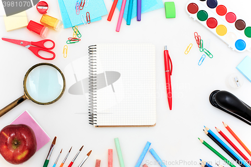 Image of School set with notebooks, pencils, brush, scissors and apple on white background