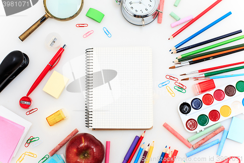 Image of School set with notebooks, pencils, brush, scissors and apple on white background