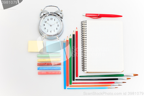 Image of School set with notebooks, pencils, brush, scissors and apple on white background
