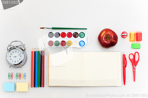 Image of School set with notebooks, pencils, brush, scissors and apple on white background