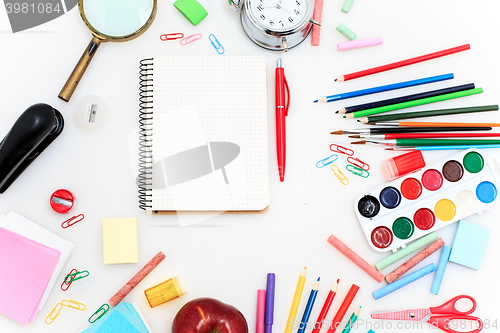 Image of School set with notebooks, pencils, brush, scissors and apple on white background