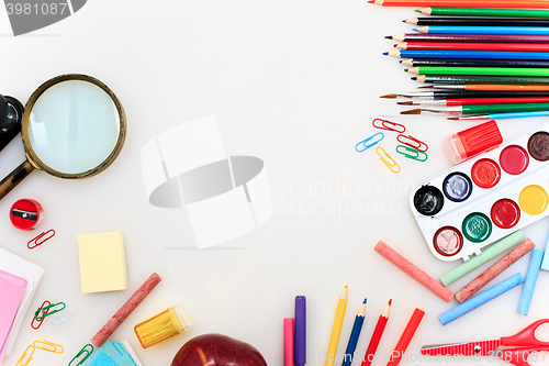 Image of School set with notebooks, pencils, brush, scissors and apple on white background