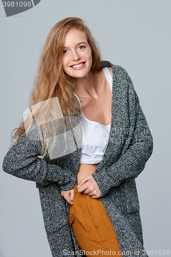 Image of Laughing woman in warm knitted cardigan