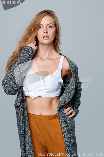 Image of Fashionable beautiful woman in warm knitted cardigan